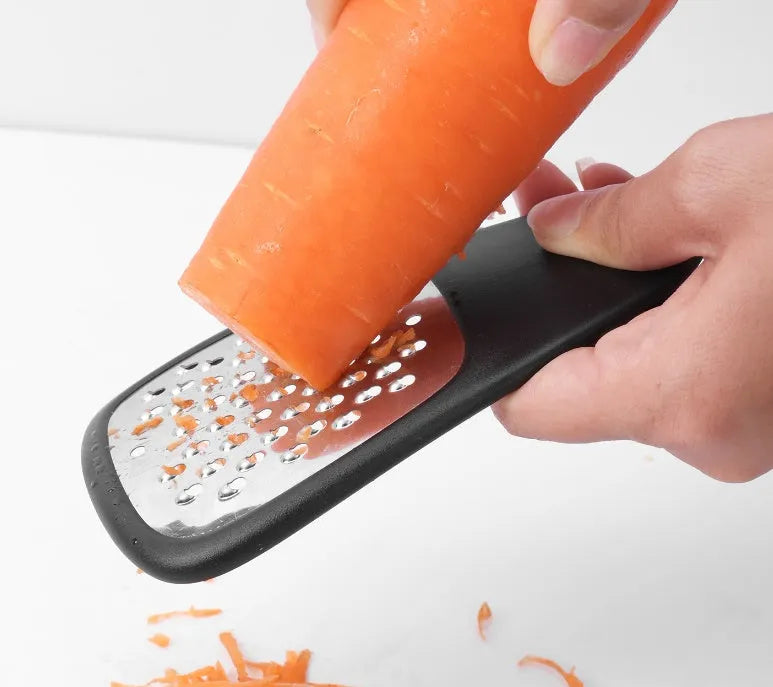 Six kitchen gadgets including wire whisk, dough scraper, potato peeler, garlic press, pizza cutter and bottle opener in colour box packaging