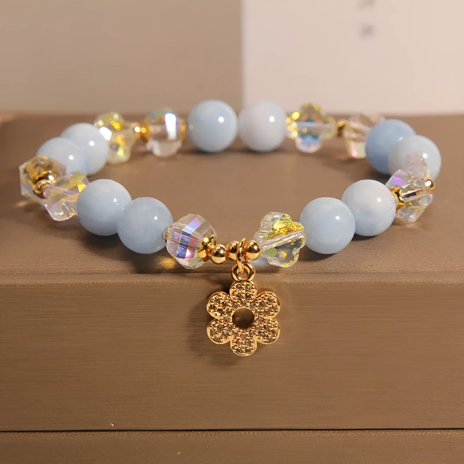 Women's aquamarine crystal four-leaf clover bracelet with pearl detail on adjustable silver chain