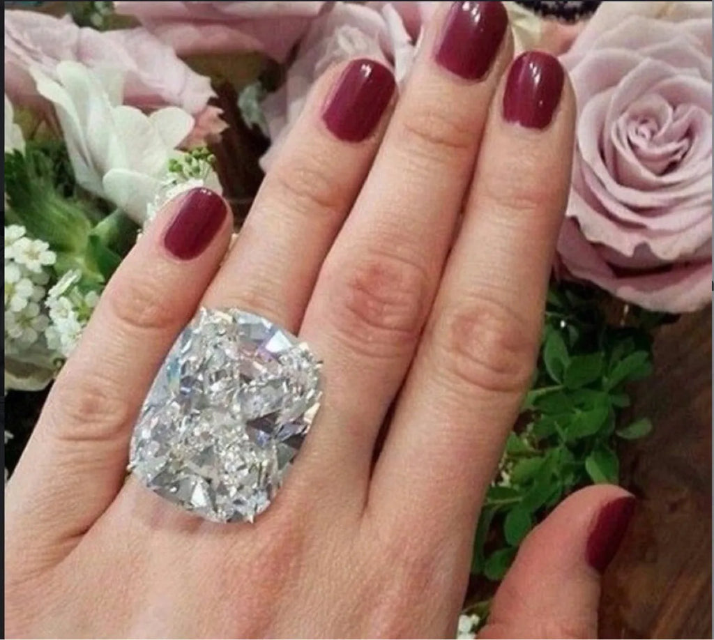 Women's white gold colour alloy ring with a simple inlaid square diamond on a geometric band.