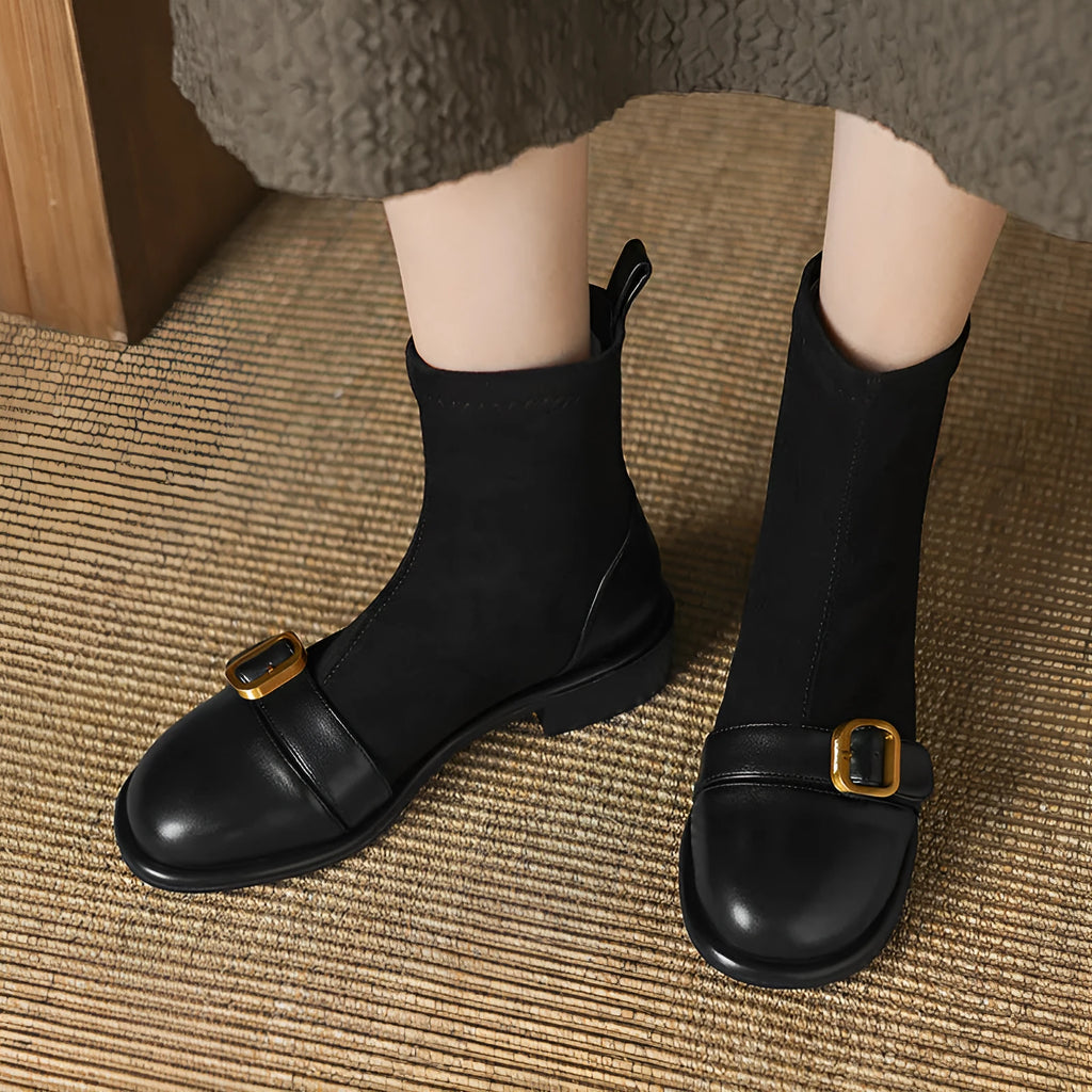 Women's black low heel Martin-style ankle boots with belt buckle stitching and front lace-up fastening.