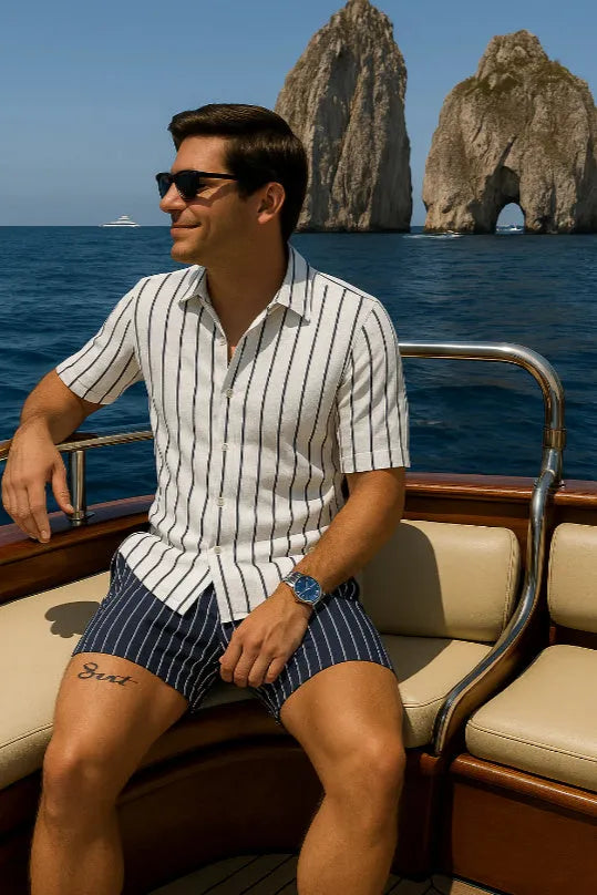 Men's light blue beach set consisting of a short-sleeve shirt and matching elastic shorts on a neutral background.