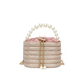 Round women's crossbody bag with beaded pearl details and single shoulder strap in retro styling