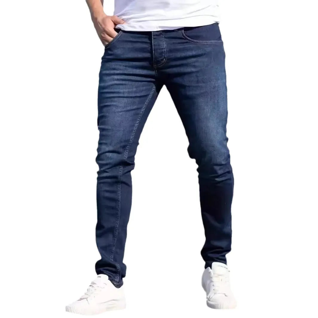 Men's dark blue slim fit cotton jeans with skinny leg opening and mid waist