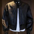 Men's black PU leather jacket with extended length and distinctive texture