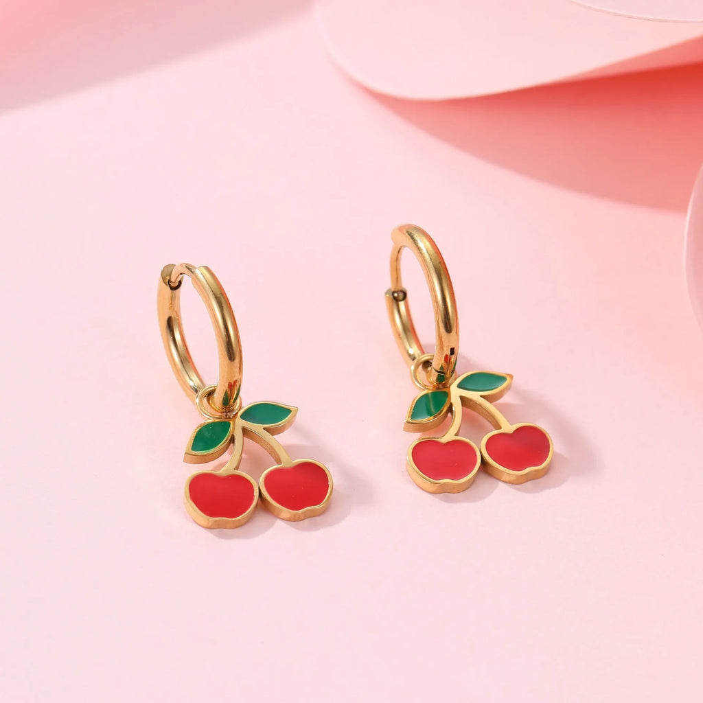 Cherry motif stainless steel jewellery set with gold plating, showing necklace, bracelet, earrings, and ring.