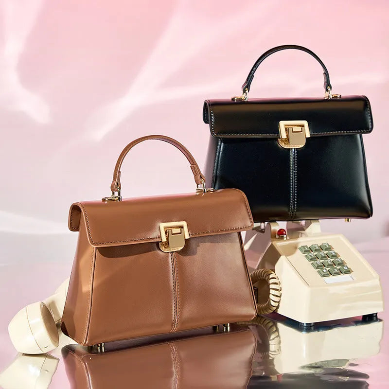 Genuine leather women's shoulder bag with clasp closure showing interior hidden compartment