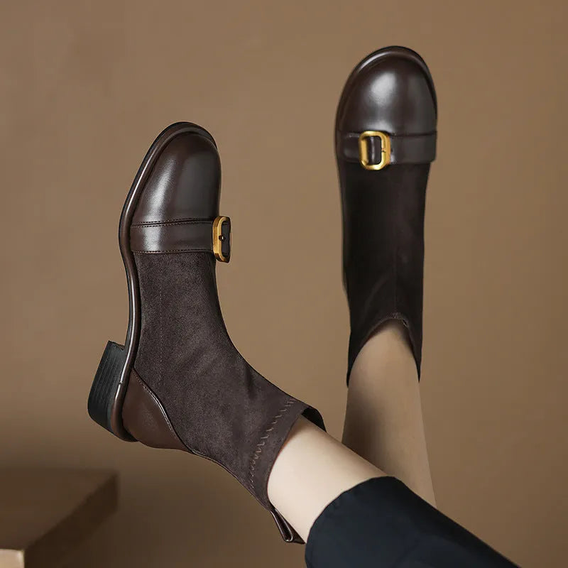 Women's black low heel Martin-style ankle boots with belt buckle stitching and front lace-up fastening.