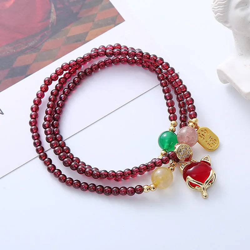Purplish red garnet crystal bracelet with fox charm and adjustable rope