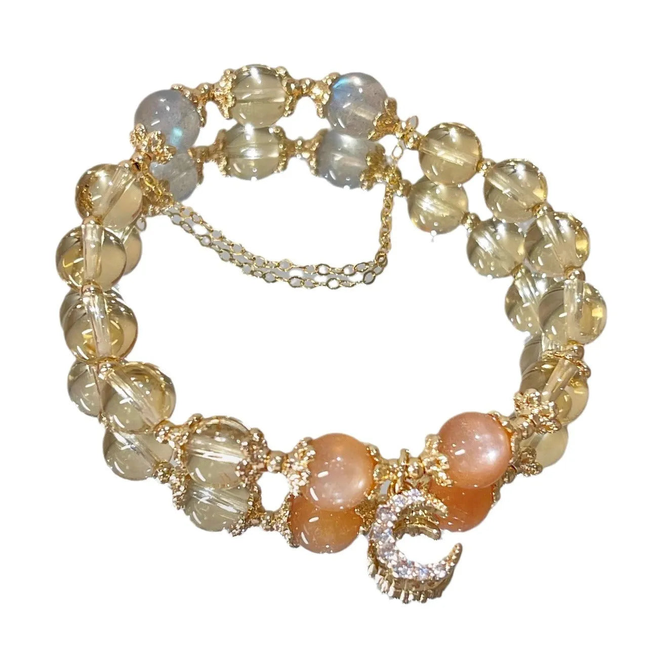 Gold electroplated women's crystal bracelet with diamond shape and fortune charm.