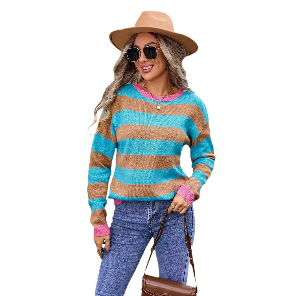 Woman wearing a loose blue and white striped acrylic sweater with long sleeves and a round neck.