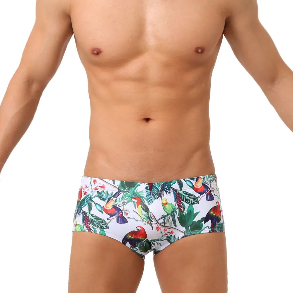 Men's swimming trunks with a colourful floral and bird print, shown in briefs and boxers styles.