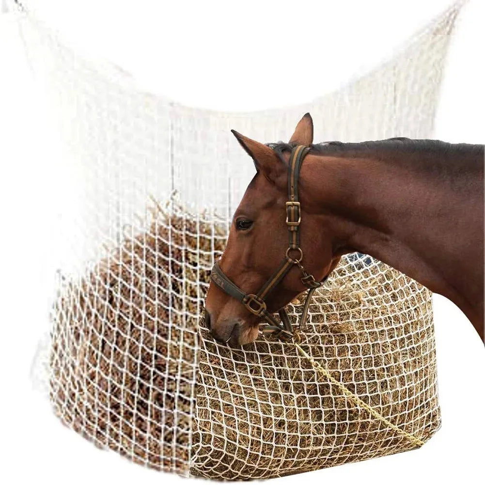Woven grid horse feeding bag hanging with hay, shown in black colour