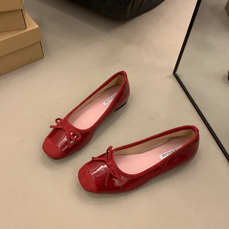 Women's wine red Mary Jane flats with square toe, decorative bow, and a low rubber sole.