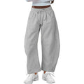 Loose cropped sweatpants with drawstring waist in apricot colour showing side pockets and street fashion styling