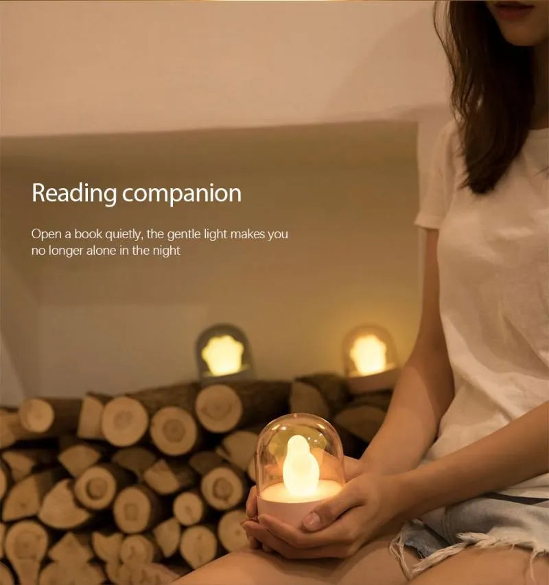 Grey and pink cat paw shaped night light with USB charging cable and musical rotation feature