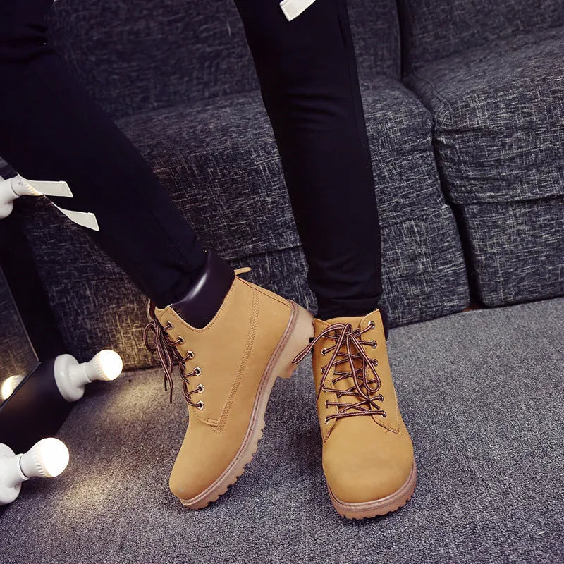 Pink high-top Martin boots with velvet lining, round toe, and front lace-up closure on a flat sole.