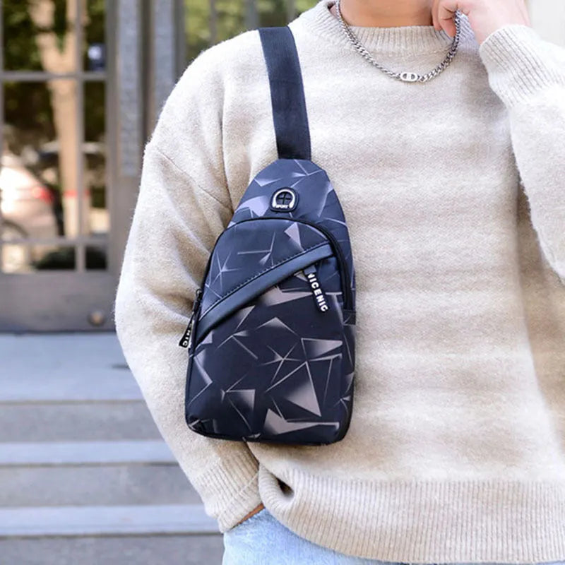 Men's medium blue Oxford cloth crossbody bag showing earphone hole and zipper opening.