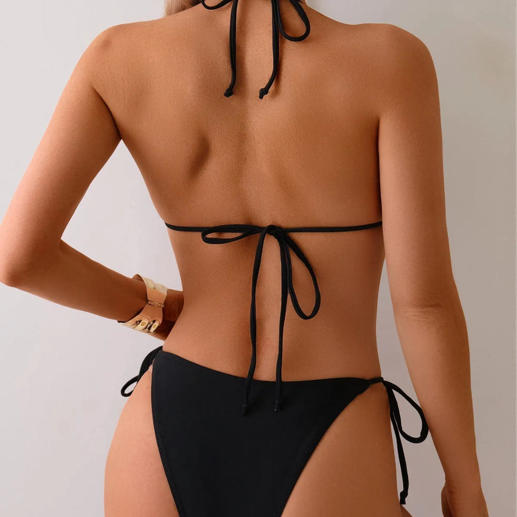 Black women's bikini swimsuit with metal bead detailing and split design