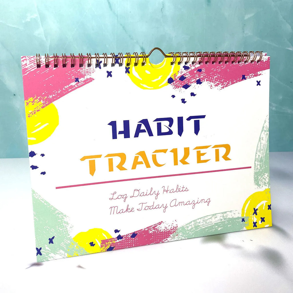 A4 habit tracking journal open showing 12 internal pages for schedule planning