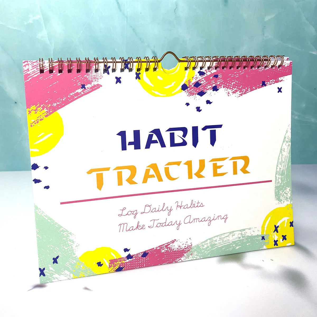 A4 habit tracking journal open showing 12 internal pages for schedule planning