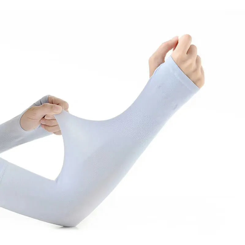 A person wearing a light grey nylon sun protection oversleeve on their arm with open fingers, suitable for driving.