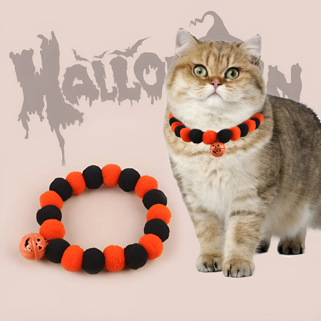 Orange Halloween cat collar with pumpkin print, breakaway buckle, and bell on a fabric band.