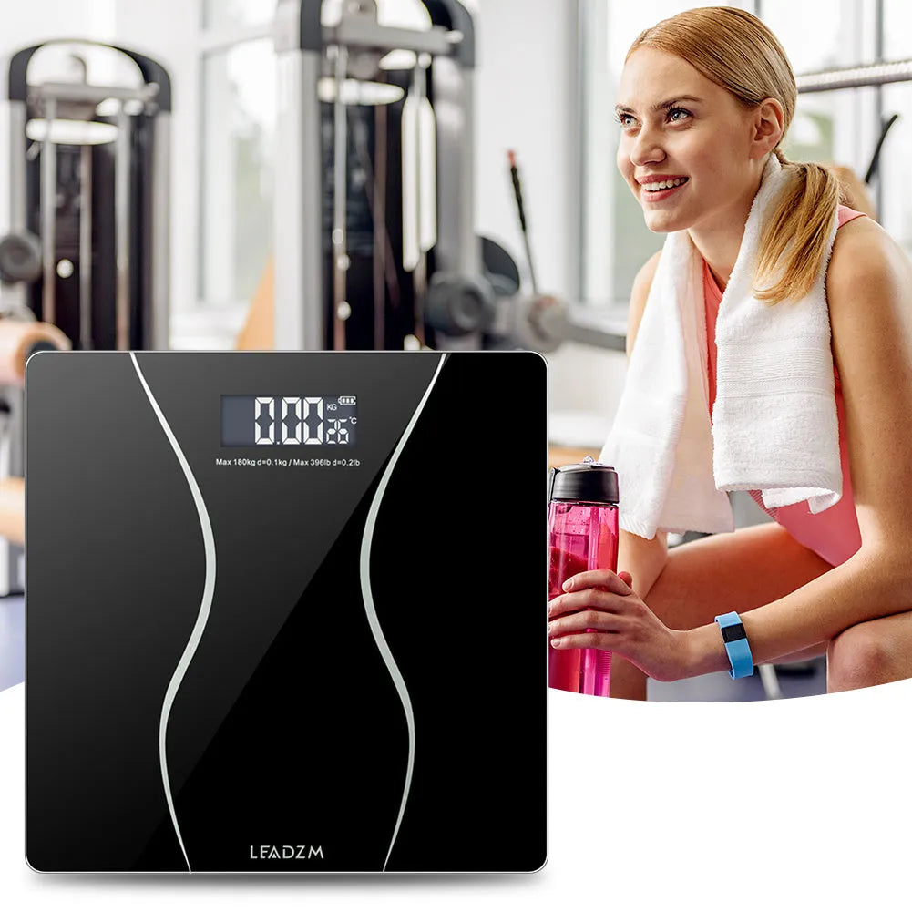 Black electronic body scale with digital display showing weight measurement up to 180KG