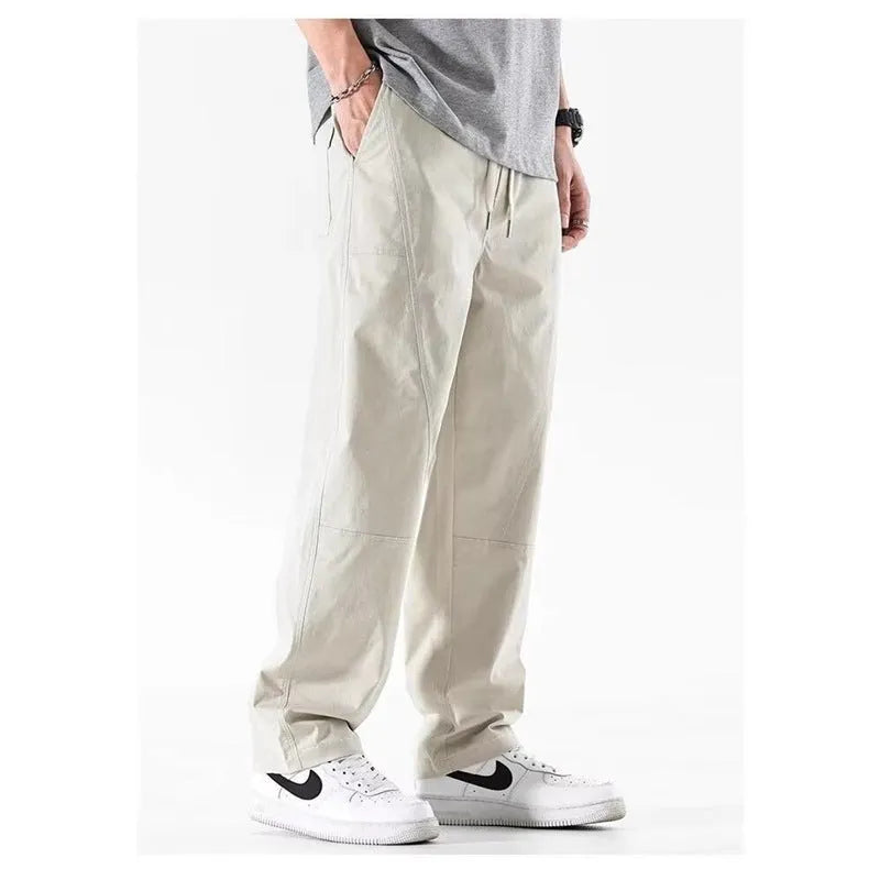 Milky white cotton wide-leg casual trousers with an elasticated waistband laid flat.