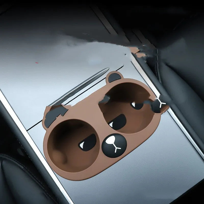 A grey silicone insert designed for a car centre console cup holder.