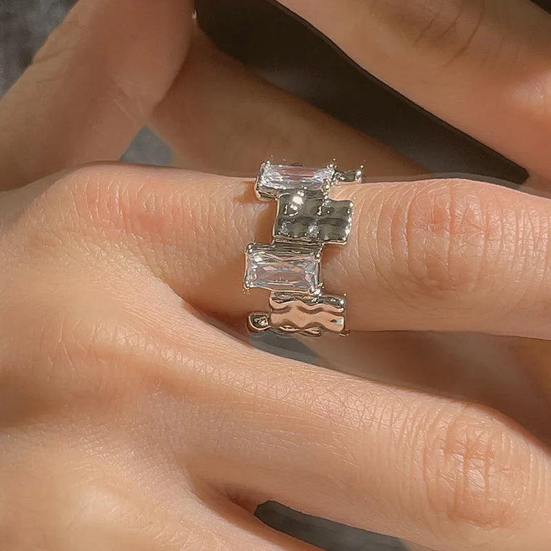 Silver plated open ring with geometric cross zircon and retro design.