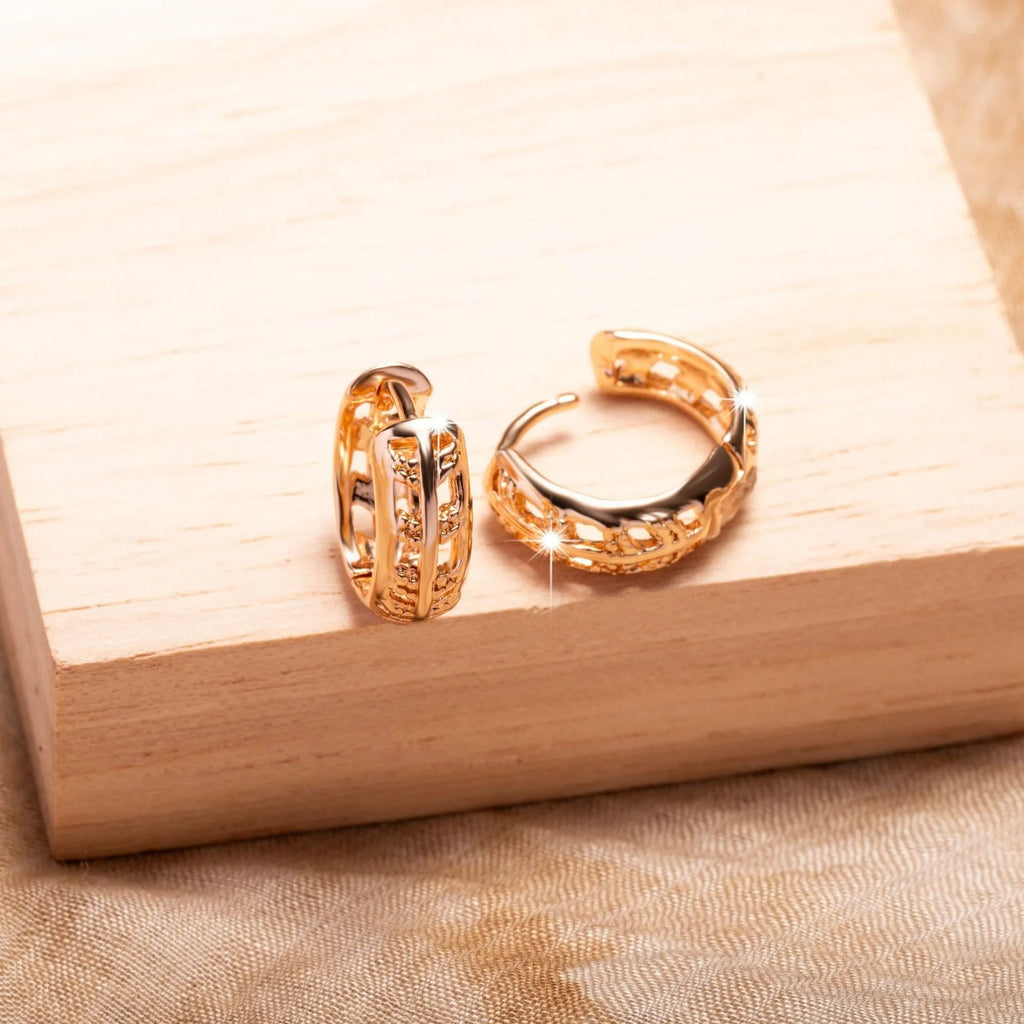 Rose gold coloured hollowed out copper earrings featuring a leaf and heart shape design.