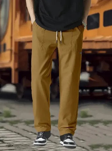 Men's light grey polyester trousers for spring and autumn seasons laid flat.