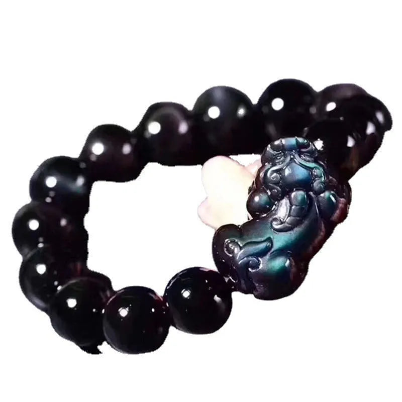 Natural eye obsidian crystal bracelet in ice colour on a wrist, showing bead sizing options.