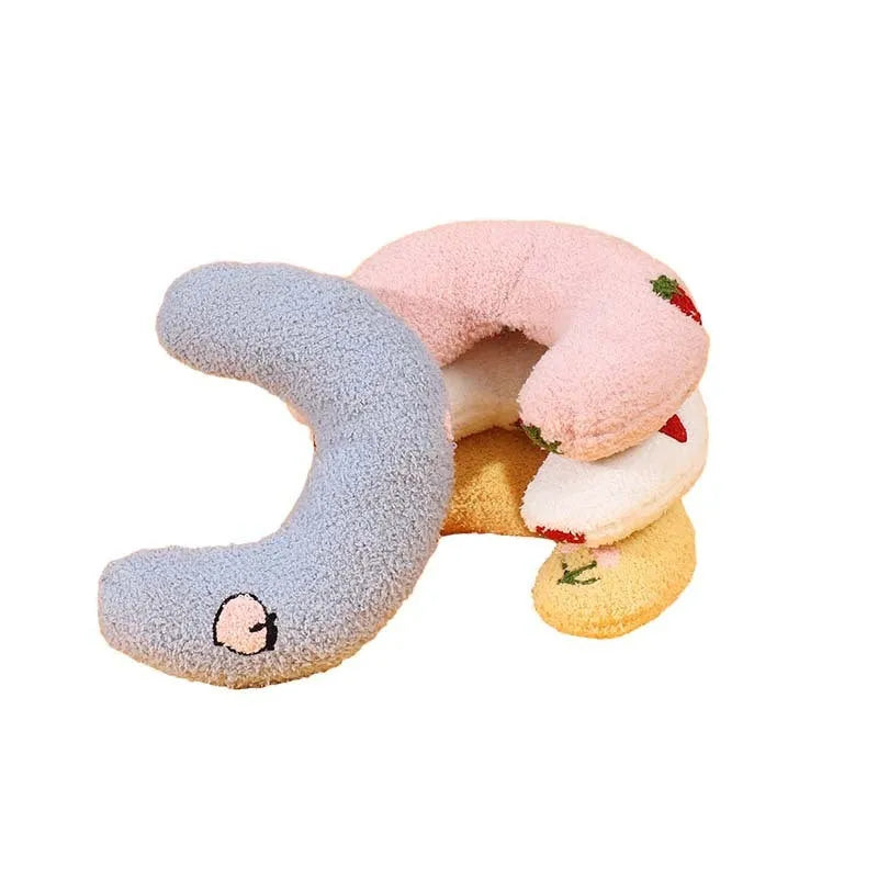 Blue U-shaped half moon pillow with cartoon dog print for pet carriers and cages.