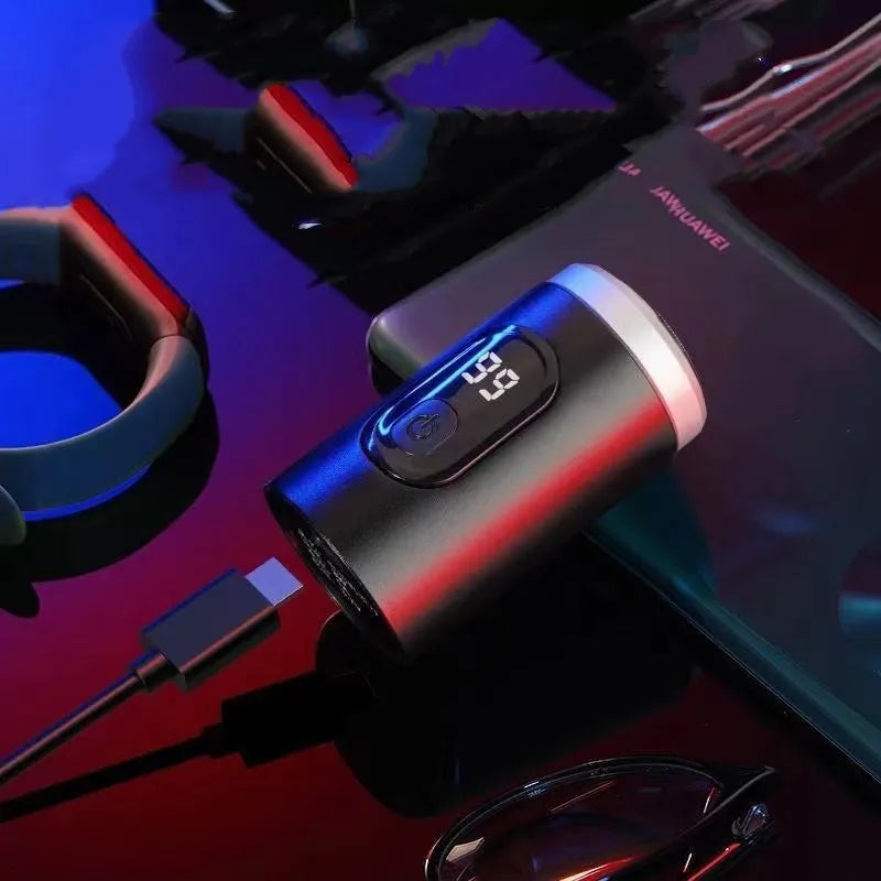 Black portable USB rechargeable electric shaver with LED display, shown with its cleaning brush and protective cover.