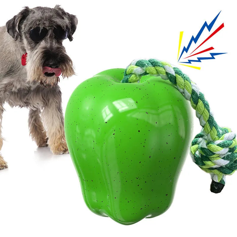 Green plastic dog toy shaped like apple with food dropping hole and molar chewing texture