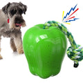 Green plastic dog toy shaped like apple with food dropping hole and molar chewing texture