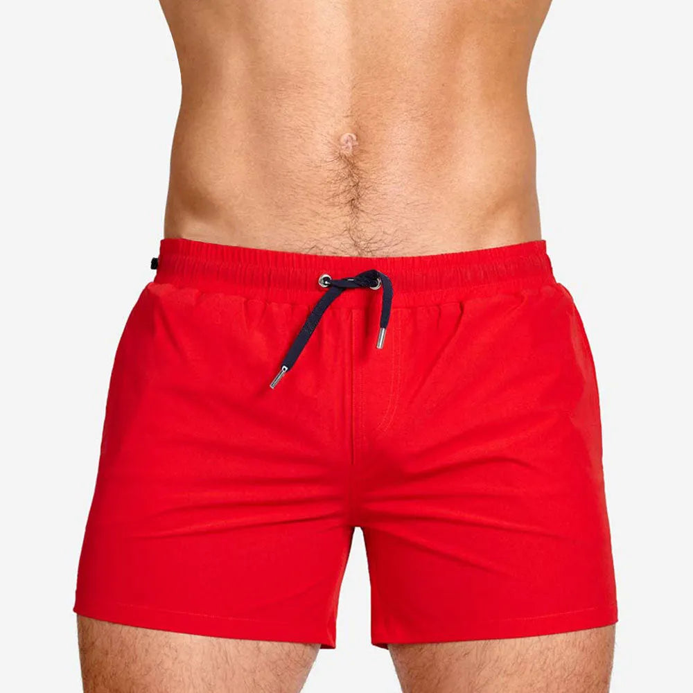 Man's solid colour polyester swimming shorts with mesh lining for sports and fitness.