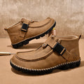 Men's black casual slip-on flat shoes with visible handmade stitching around the sole.