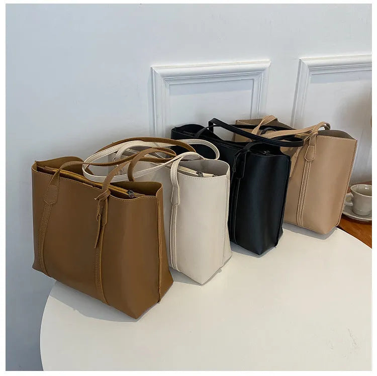 Large capacity soft leather tote bag in beige with synthetic leather lining and double shoulder straps.