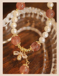 Women's strawberry quartz crystal bracelet with bow detail on wrist