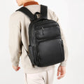 Large capacity men's black business commute backpack in composite cowhide PU with 20-35L capacity and curved shoulder straps