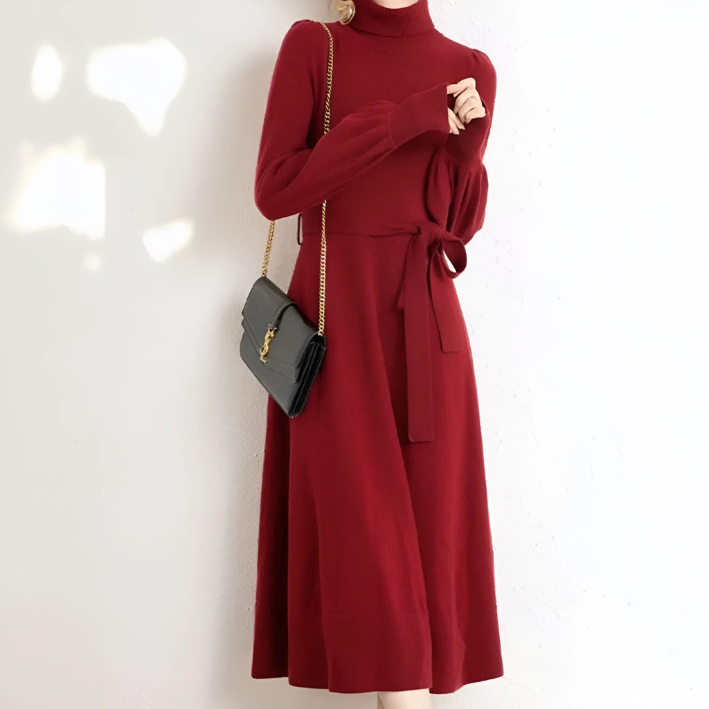 Turtleneck knitwear dress with elastic waist and loose mid-length skirt in solid colour.