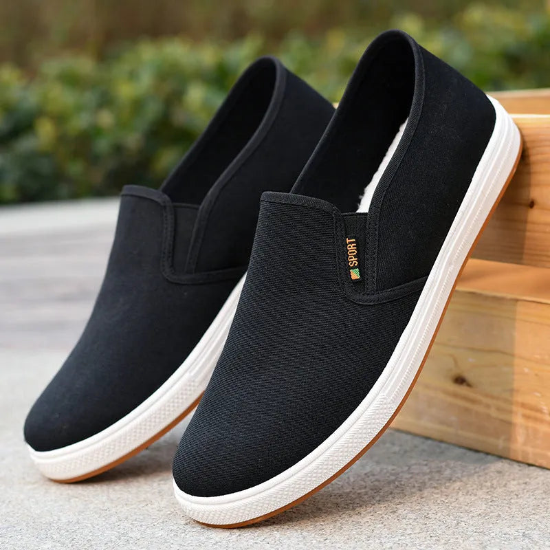 Men's black and blue canvas slip-on shoes with shallow cut design and composite soles