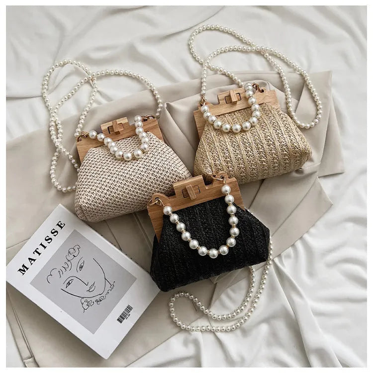 Beige straw woven women's shoulder bag with pearl chain strap showing front view