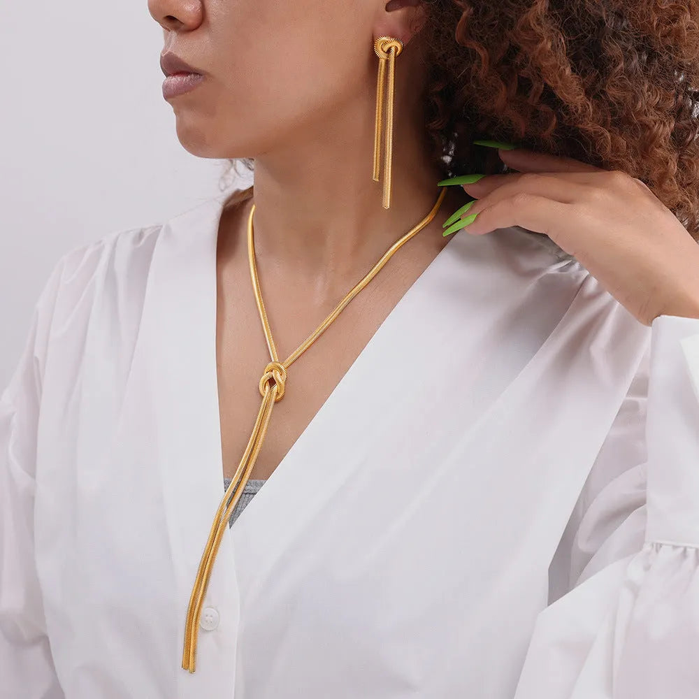 Gold electroplated titanium steel necklace with knotted tassel pendant and matching earrings set for women