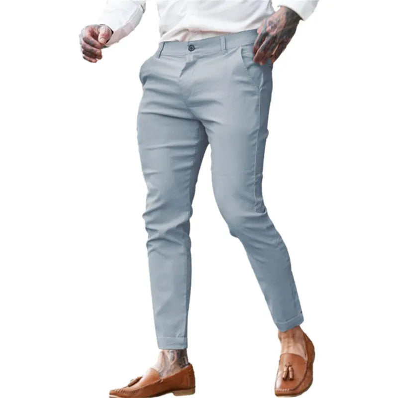 Men's slim fit stretch cotton pencil pants in a solid colour on a model.