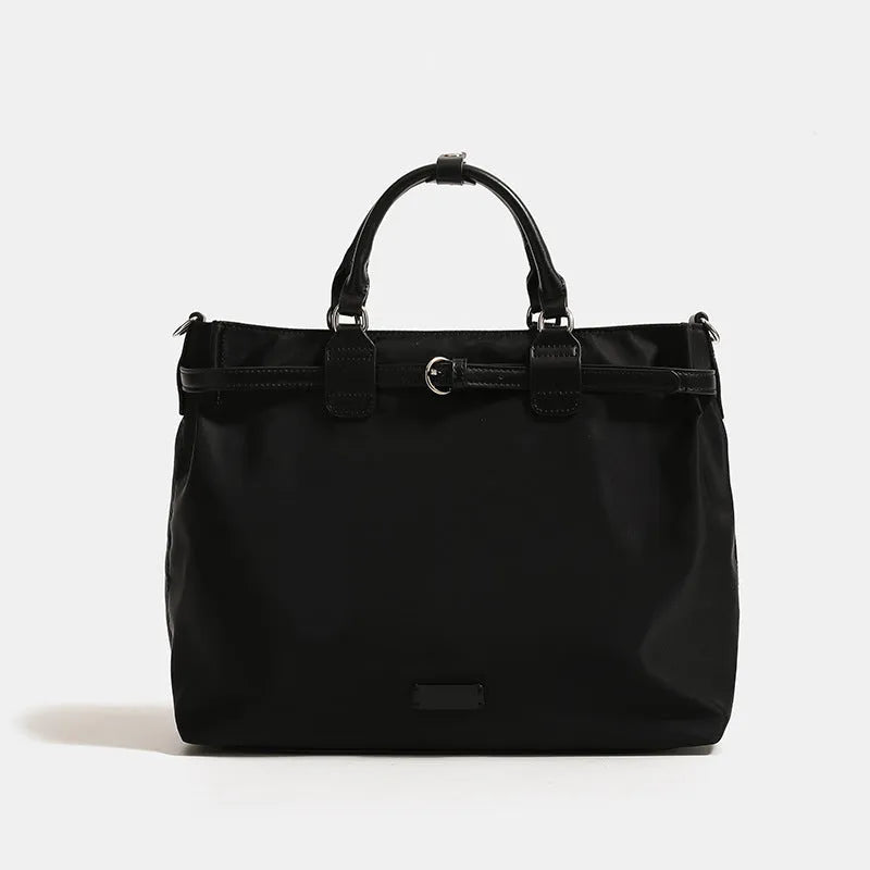 Women's nylon shoulder tote bag in a horizontal square shape showing internal organiser pockets.