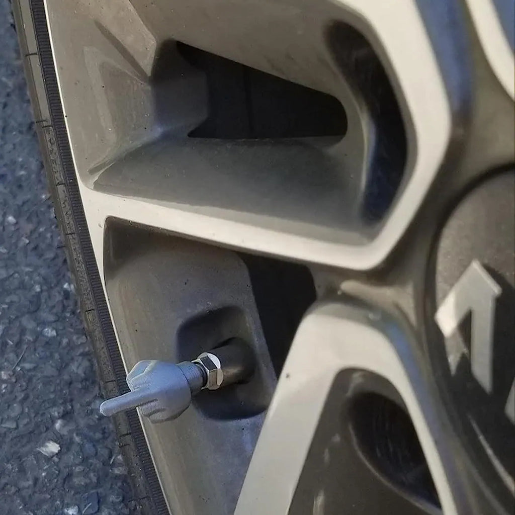 Four latex car tyre valve dust caps, shown in black and skin colour, arranged on a surface.