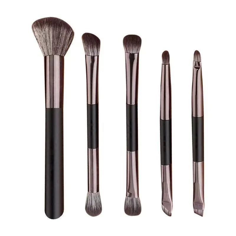 Makeup brush set with mirror showing silver or gold finished brushes with artificial fibre bristles
